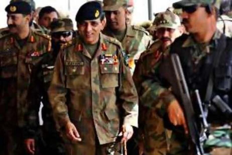 To go with Pakistan-politics-military-Kayani,PROFILE by Nasir Jaffry<br />(FILES) In this picture taken on April 18, 2010 Pakistani Army Chief General Ashfaq Kayani (C) is escorted by army commandos as he arrives to watch the military exercise in Bahawalpur. Pakistan Prime Minister Yousuf Raza Gilani on July 22 gave powerful army chief General Ashfaq Kayani a three-year extension in the top job. Kayani, Pakistan's powerful army chief of staff, has masterminded decisive battles against the Taliban and kept the military out of politics. As head of the largest branch of Pakistan's military, the 58-year-old is the most powerful man in the country and commands respect from the armed forces, civilian government and the masses, but is rarely in public. AFP PHOTO / AAMIR QURESHI *** Local Caption ***  058142-01-08.jpg