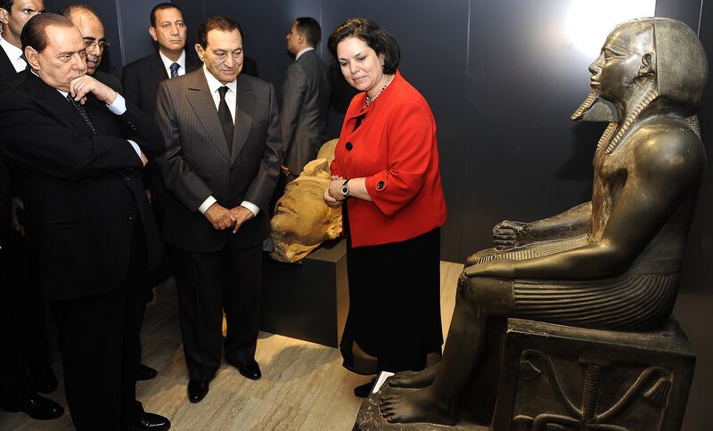 Egyptian President Hosni Mubarak, Mr Berlusconi, left, and director of the Egyptian Museum in Cairo Wafaa Elsaddik visit the Egyptian Academy in Rome, in September 2010. AFP