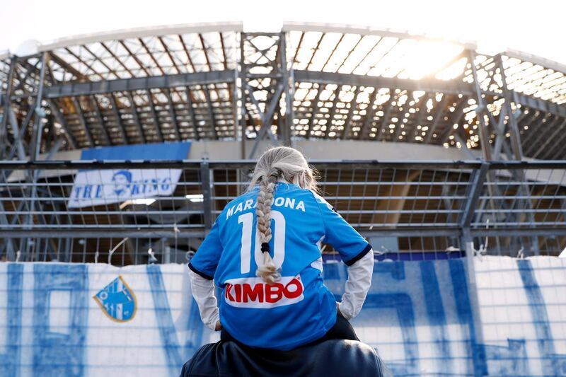 A girl wearing a Diego Maradona shirt is seen outside the Stadio San Paolo in Naples. Reuters