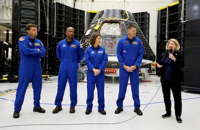 The astronauts taking part in the Artemis 2 mission in front of the Orion craft which will take them to the Moon. Reuters