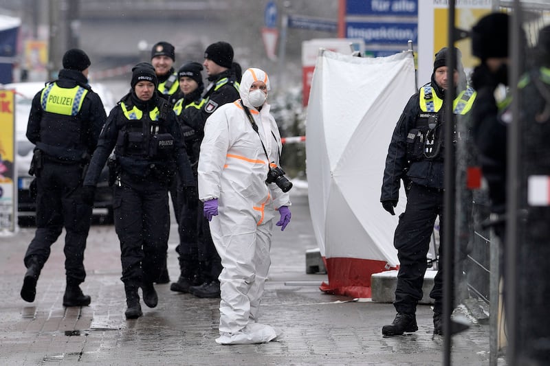 Officers outside the Jehovah's Witness building in Hamburg where several people were shot dead. AP
