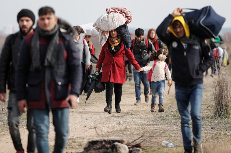 Refugees and migrants walk in a dirty road heading to the Turkish-Greek border and trying to enter Europe, in Edirne, Turkey.  EPA