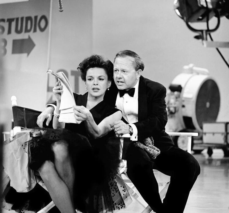 Judy Garland and Mickey Rooney put their heads together over a television script for their first onstage reunion in 18 years, for the taping of the first of 32 variety shows on June 26, 1963. AP Photo / File