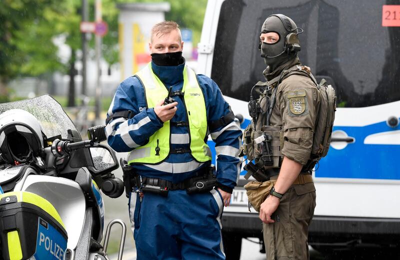 Police officers are seen guarding the Higher Regional Court in Frankfurt am Main on June 16, 2020 for the start of the trial of the accused of killing politician Walter Luebcke, who belonged to Chancellor Angela Merkel's conservative CDU party and headed the Kassel regional council in the western state of Hesse. A German neo-Nazi stands trial Tuesday on charges of murdering pro-refugee politician Walter Luebcke, in a case that shocked the country and highlighted the growing threat of right-wing extremism. Federal prosecutors believe the main suspect, 46-year-old Stephan E, was motivated by "racism and xenophobia" when he allegedly drove to Luebcke's house on June 1, 2019 and shot him in the head. / AFP / THOMAS KIENZLE
