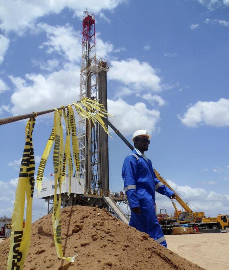 An engineer walks past an oil rig at the Ngamia-1 well in the Lokichar basin, which is part of the East African Rift System in Kenya.  Njuwa Maina / Reuters