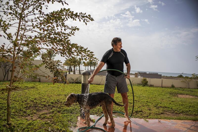 Carlos Duarte, professor of Marine Science and Tarek Ahmed Juffali Research Chair in Red Sea Ecology at  KAUST, washes his dog at his home at the campus. Reuters