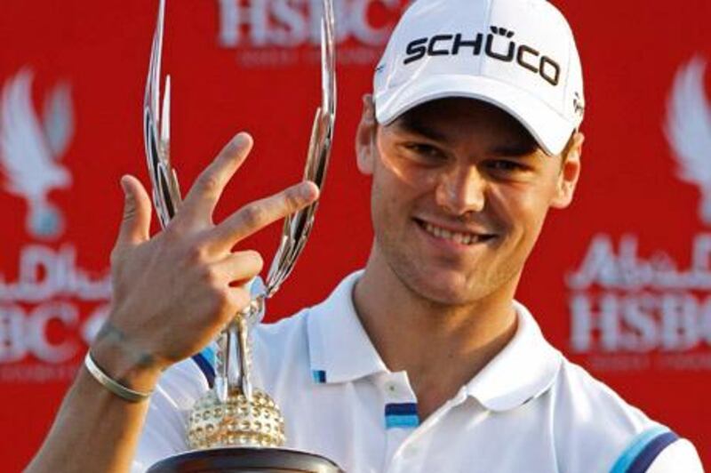 Abu Dhabi, January 23, 2010 - Martin Kaymer signifies winning the Abu Dhabi Golf Championship Tournament threes times as he holds the winner's trophy at the Abu Dhabi Golf Course in Abu Dhabi January 23, 2011(Jeff Topping/The National)