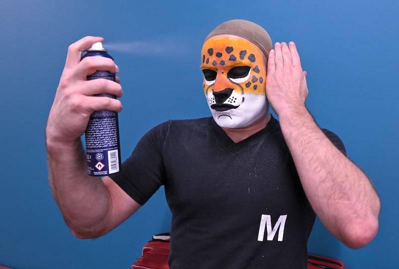 Wagner sets his jaguar face paint before the show