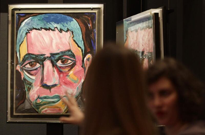A painting by David Bowie is set up for the upcoming David Bowie exhibition in Berlin, 14 May, 2014. David Bowie's intensely productive Berlin period - when he made the iconic albums Heroes and Low, launched Iggy Pop's solo career and kicked a drug habit - is the theme of a new show adapted from last year's sold-out exhibition in London. The exhibition runs from 20 May till 10 August in the German capital. Reuters