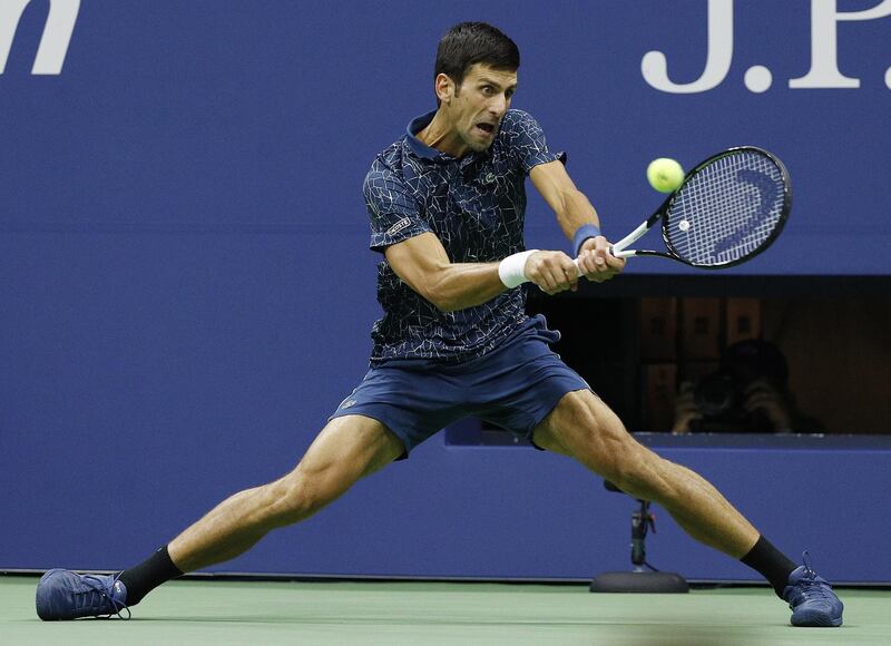 Novak Djokovic of Serbia hits a return to Juan Martin del Potro of Argentina.  EPA