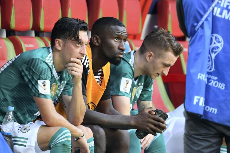 (From L) Germany's midfielder Mesut Ozil, Germany's defender Antonio Ruediger and Germany's forward Marco Reus react at the end of the Russia 2018 World Cup Group F football match between South Korea and Germany at the Kazan Arena in Kazan on June 27, 2018. / AFP PHOTO / SAEED KHAN / RESTRICTED TO EDITORIAL USE - NO MOBILE PUSH ALERTS/DOWNLOADS