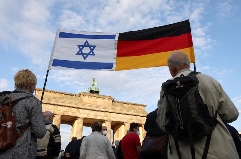 People carry an Israeli and a German flag during a rally in solidarity with Israel and against antisemitism, in front of the Brandenburg Gate in Berlin, Germany, May 20, 2021. REUTERS/Christian Mang