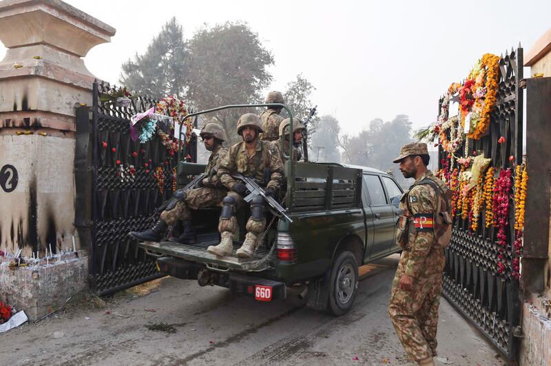 Pakistani soldiers patrol an army-run school in Peshawar, after it was attacked by Taliban militants. AFP