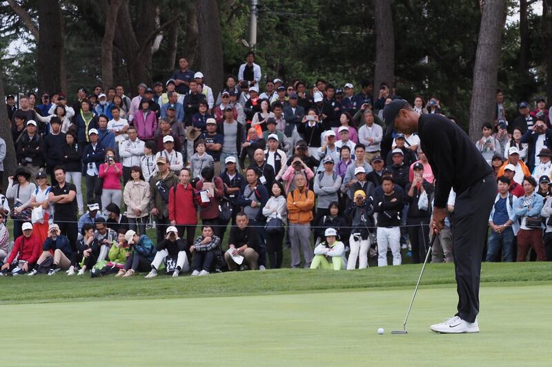 Tiger Woods putts on the 5th hole. AFP