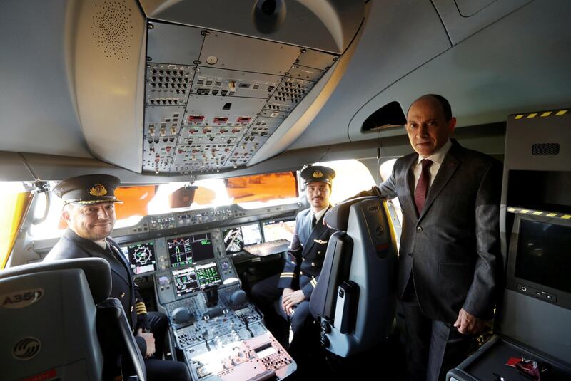 FILE PHOTO: Qatar Airways Chief Executive Officer Akbar al-Baker poses with pilots in the cockpit of an Airbus A350-1000 at the Eurasia Airshow in the Mediterranean resort city of Antalya, Turkey April 25, 2018. REUTERS/Murad Sezer/File Photo