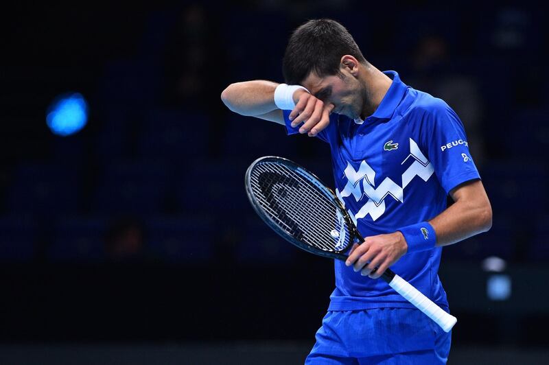 Serbia's Novak Djokovic reacts during his match agaainst Russia's Daniil Medvedev during their men's singles round-robin match on day four of the ATP World Tour Finals tennis tournament at the O2 Arena in London on November 18, 2020.  / AFP / Glyn KIRK                          

