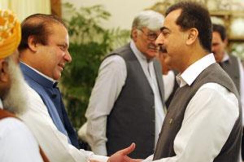 Pakistan's prime minister Yousuf Raza Gilani (R) shakes hands with former premier Nawaz Sharif (2 L) prior to start an All Parties Conference over the ongoing military operation against Taliban, in Islamabad on May 18, 2009.