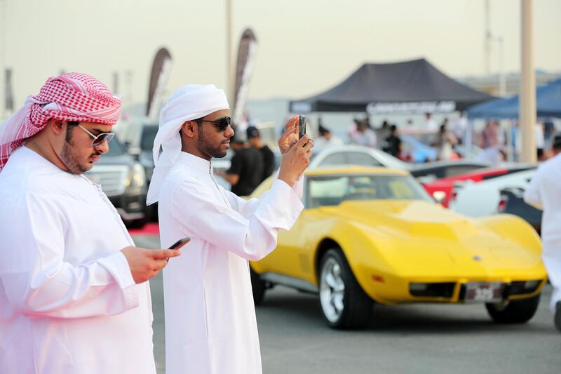 Dubai, United Arab Emirates - November 16, 2018: A visitor takes photos at the annual Gulf Car Festival. Friday the 16th of November 2018 at Festival City Mall, Dubai. Chris Whiteoak / The National
