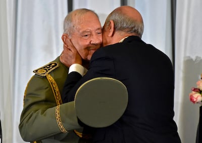 (FILES) In this file photo taken on December 19, 2019 Algerian President Abdelmadjid Tebboune (R) embraces and kisses armed forces chief Lieutenant general Ahmed Gaid Salah (L), during the formal swearing-in ceremony in the capital Algiers. Algeria's powerful army chief Ahmed Gaid Salah died, state TV said on December 23, 2019. / AFP / RYAD KRAMDI                        
