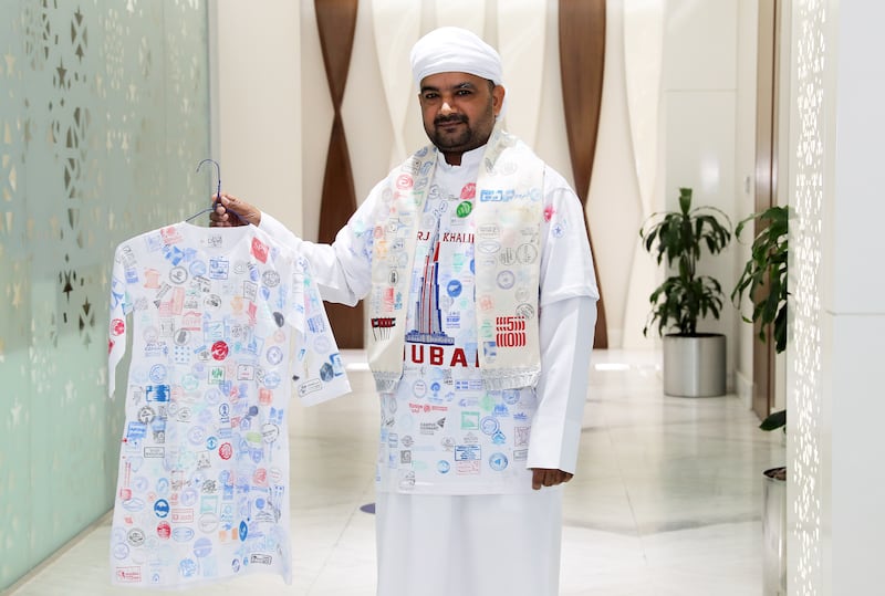 Muhammad Asim Durrani, a Dubai Customs employee, got pavilion stamps inked on his t-shirt, scarf and a small kandora. Pawan Singh/The National.