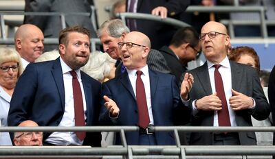 Manchester United group commercial director Richard Arnold, left, with joint chairmen Joel Glazer and Avram Glazer. PA
