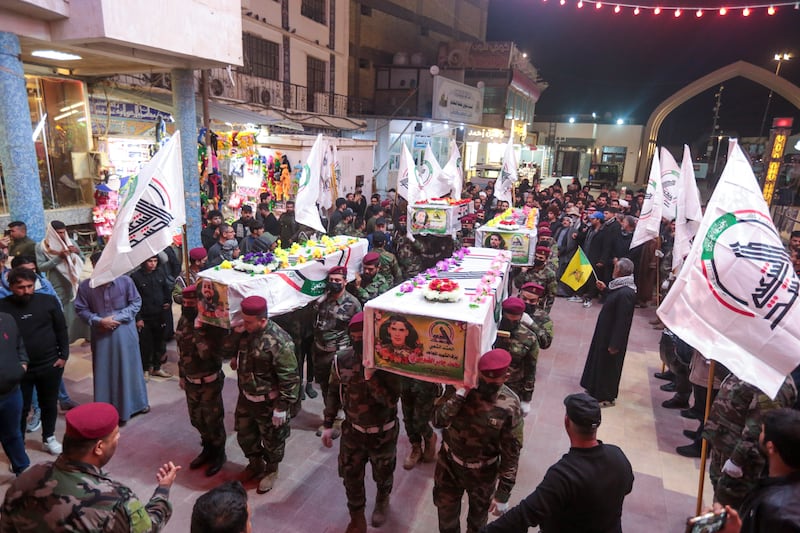 The funeral of Kataib Hezbollah members in Najaf, central Iraq. Kataib Hezbollah fighters were killed in the US air strikes in response to attacks on US forces. AP