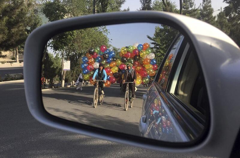 Afghan balloon vendors ride their bicycles in Kabul Rahmat Gul / AP Photo
