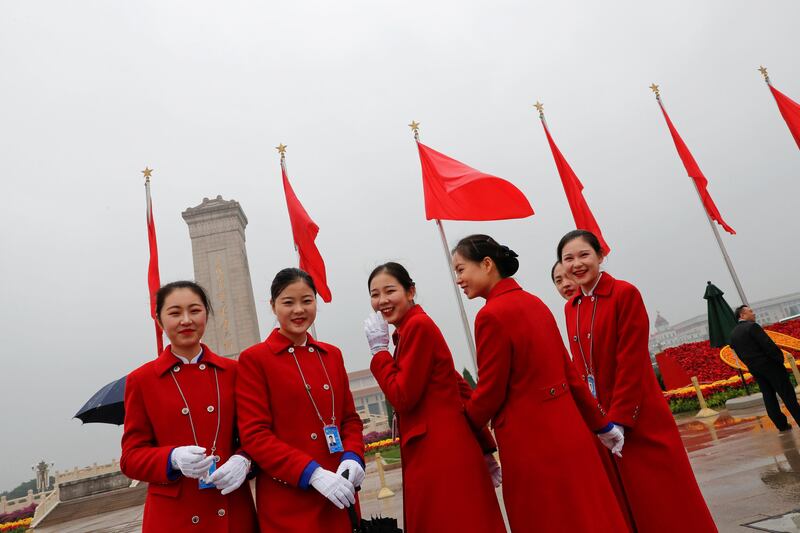 Ushers pose for pictures outside of Beijing's Great Hall of the People before the opening session of the 19th National Congress of the Communist Party of China. Tyrone Siu / Reuters