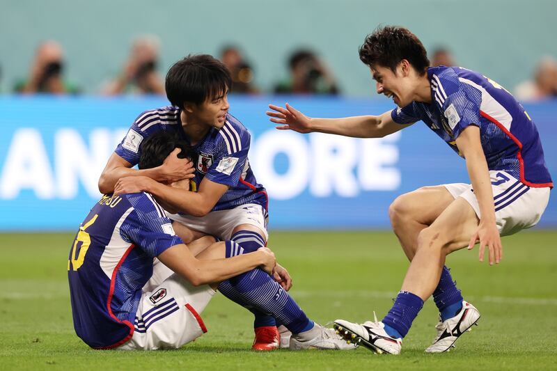 Takehiro Tomiyasu, left, and Kaoru Mitoma after Japan's famous win. Getty