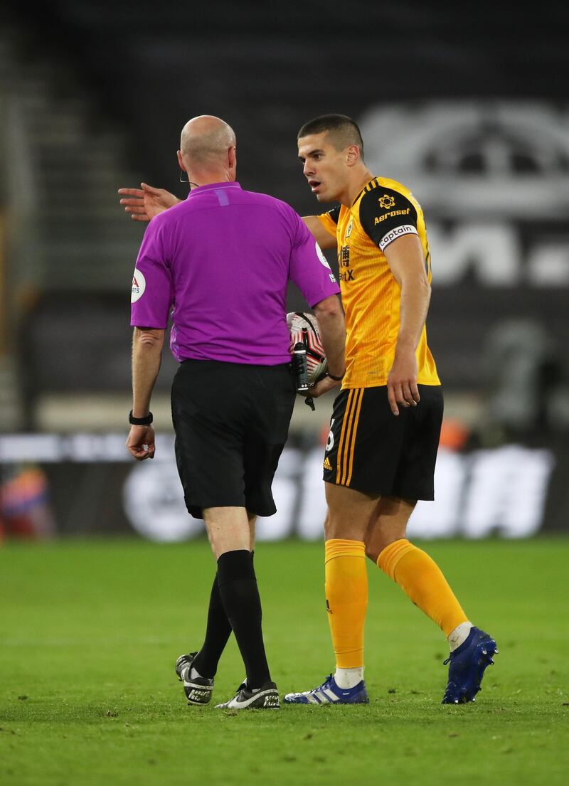 Conor Coady of Wolverhampton Wanderers interacts with referee Lee Mason. Getty
