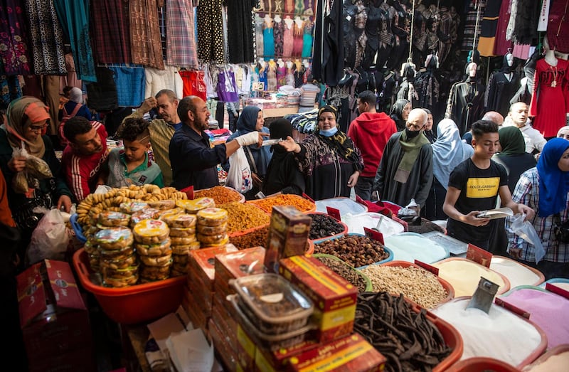 People shop at a market on the eve of the first day of Ramadan, in Cairo, Egypt, 12 April 2021. EPA