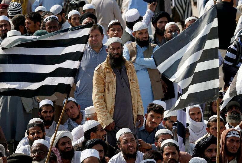 Supporters of Jamiat Ulema-e-Islam party wait for their leaders. AP Photo