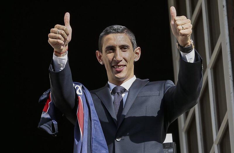 Angel Di Maria gestures to crowds from a balcony after signing with Paris Saint Germain. Ian Langsdon / EPA