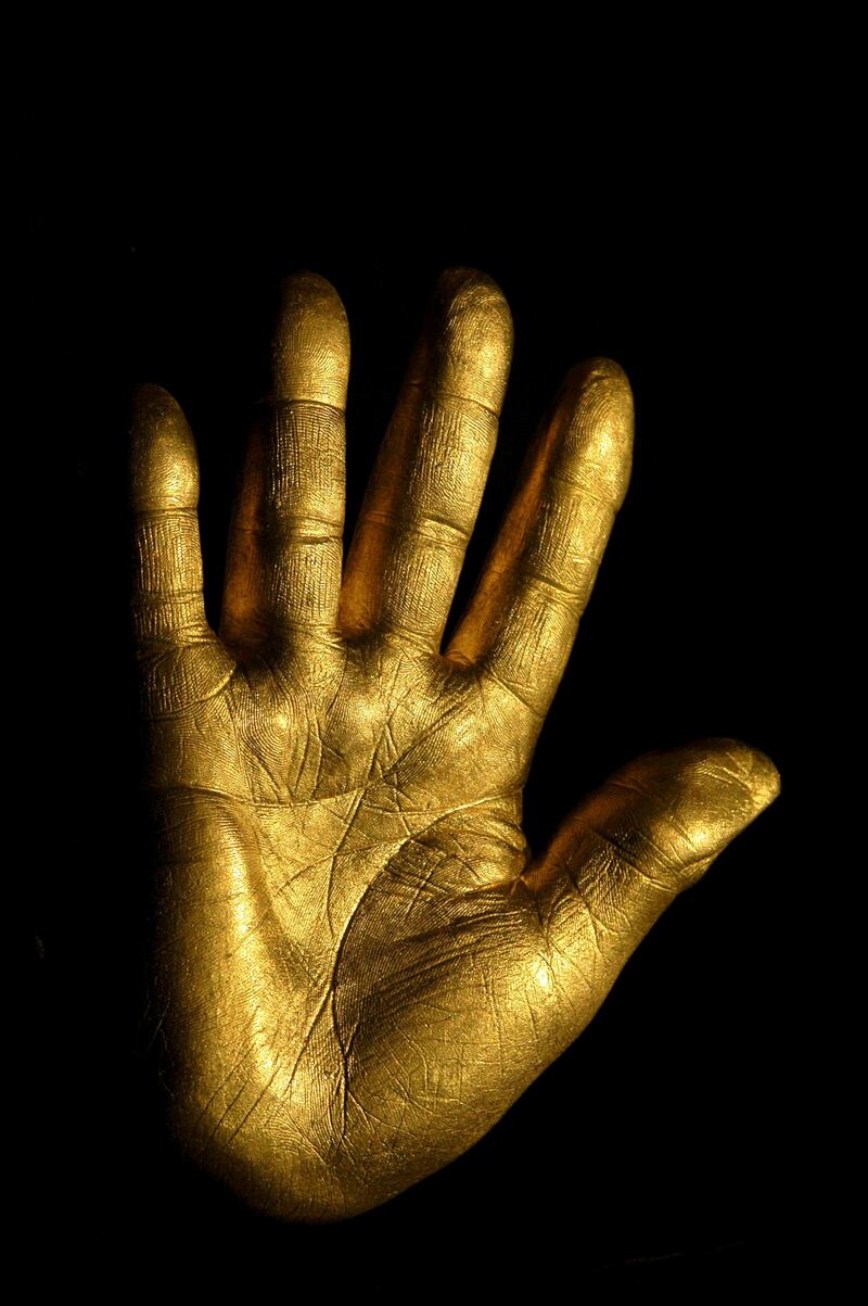 At the auction of Nelson Mandela's artwork from Robben Island, his former prison, a solid fine gold casting of Mandela's right hand was auctioned. A Johannesburg carpet dealer, Shraga Vidavsky, bought the hand for Rands 425,000 (approximately US$53,000.) The hand, 3 kilograms of pure gold, bears his signature and one of the years of his imprisonment on the back. The hand was cast by South African Harmony Gold Company. Twenty-seven hands will be made for auction, one for each year of imprisonment. The proceeds from the auction of the gold hands and of Mandela's artwork will benefit the "Nelson Mandela Trust" and the charities it supports. On July 3, another fundraising event with Nelson Mandela will be held in London. The star-studded guest list includes David Beckham and his wife. --- Photo by Louise Gubb/Corbis SABA (Photo by Louise Gubb/Corbis via Getty Images)