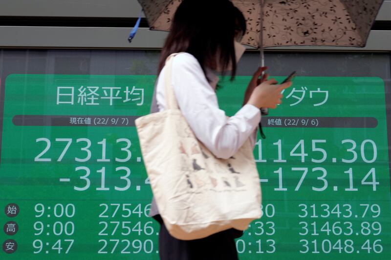 An electronic stock market board in Tokyo. The Japanese yen has slumped 20 per cent this year. AP