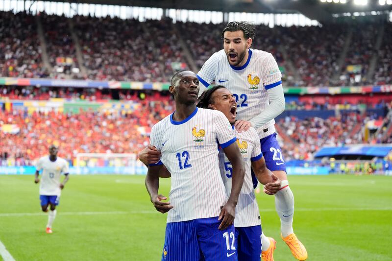 France's Randal Kolo Muani, left, celebrates with teammates after his shot was deflected in off Jan Vertonghen to give them a 1-0 Euro 2024 last-16 victory against Belgium at the Dusseldorf Arena on Monday July 1, 2024. PA 