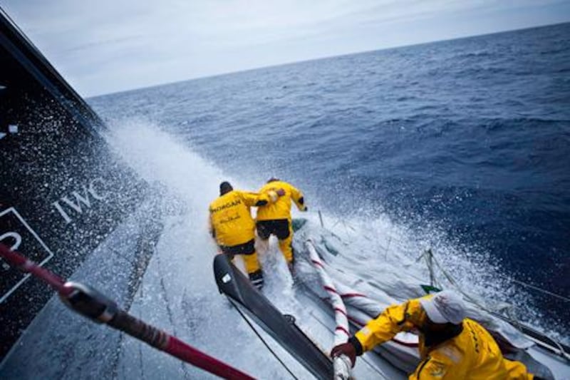 Wade Morgan and Anthony Nossiter keeping each other on their feet during a sail change, onboard Abu Dhabi Ocean Racing during leg 7 of the Volvo Ocean Race 2011-12, from Miami, USA to Lisbon, Portugal. (Credit: Nick Dana/Abu Dhabi Ocean Racing/Volvo Ocean Race)
