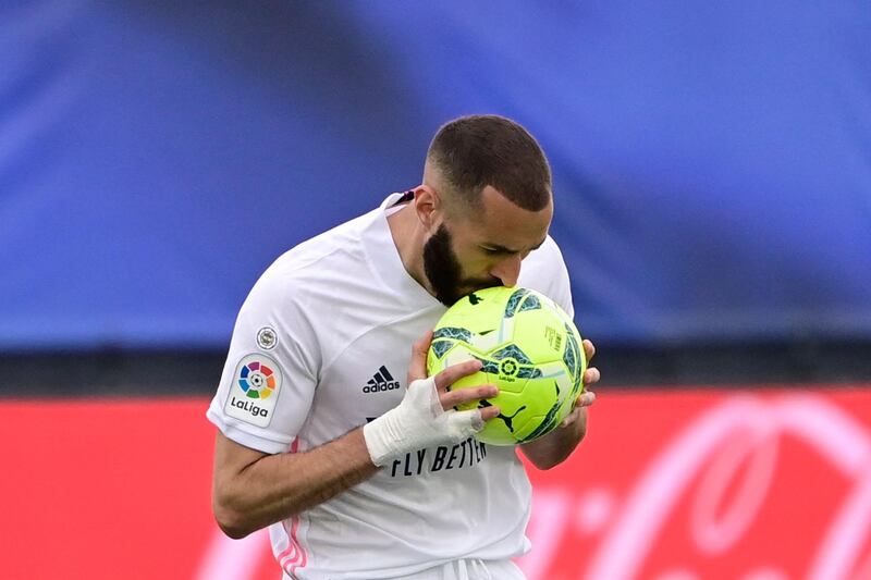 Real Madrid's Karim Benzema kisses the ball after scoring before the goal was disallowed. AFP
