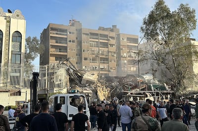 Emergency and security personnel gather at the site after a strike on the Iranian embassy in Syria's capital Damascus on Monday. AFP