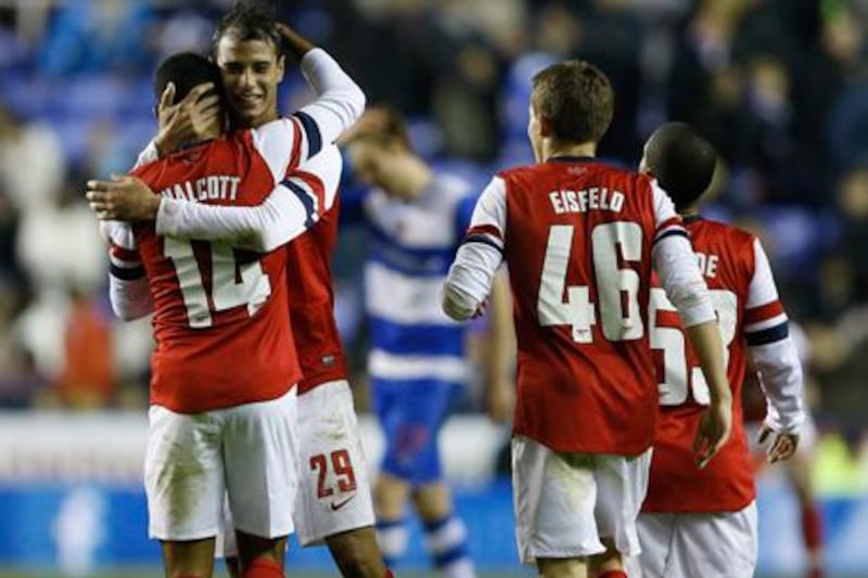 Arsenal's Theo Wallcott is congratulated by Marouane Chamakh after his last-gasp winner against Reading