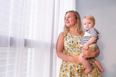 Abu Dhabi resident Lorna King, pictured with her son, tracks her spending on the budgeting app Wally. Reem Mohammed / The National