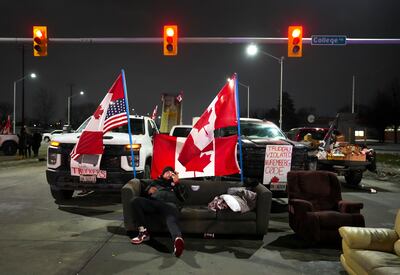 A protester blocks access to the Ambassador Bridge. AP