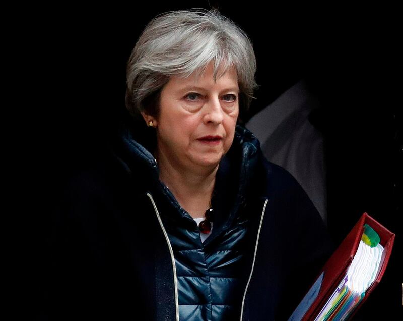 FILE - In this March 14, 2018 file photo Britain's Prime Minister Theresa May leaves 10 Downing Street to attend the weekly Prime Minister's Questions session, in parliament in London. May has summoned her Cabinet back from vacation on Thursday April 12, 2018, to discuss possible military action against Syria over an alleged chemical weapons attack. (AP Photo/Frank Augstein, file)