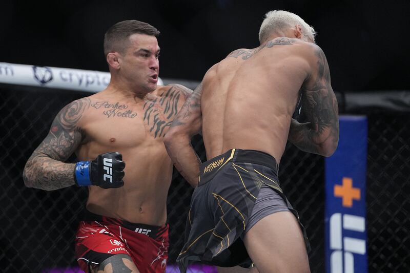 Dustin Poirier lands a hit against Charles Oliveira. Reuters