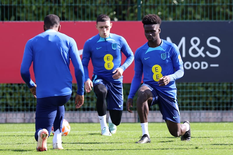 Enland attackers Bukayo Saka and Phil Foden take a stretch. Getty