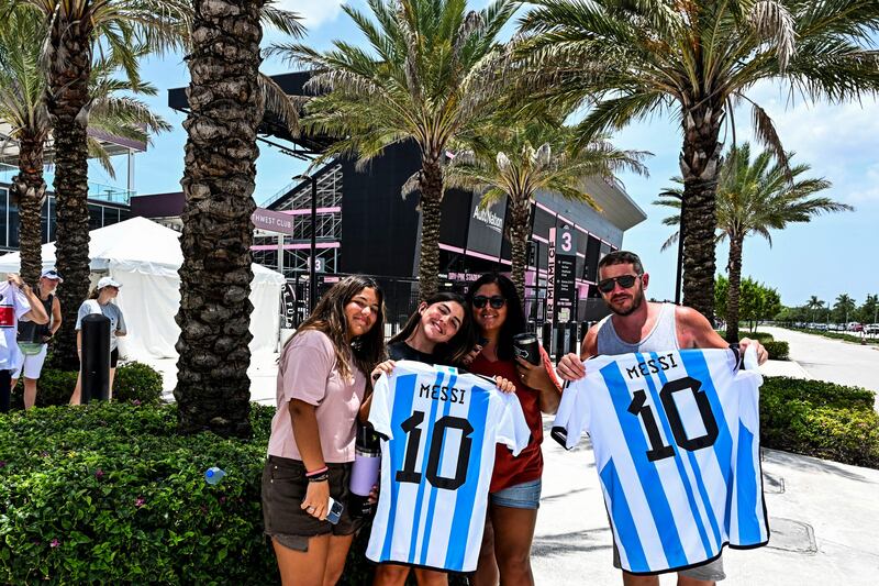 Lionel Messi fans pose for a photo while waiting for his arrival at the DRV PNK Stadium in Fort Lauderdale. AFP