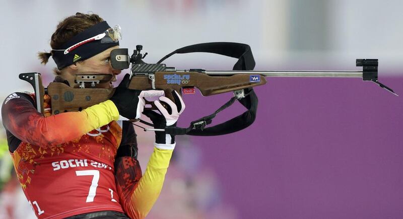 Germany's Evi Sachenbacher-Stehle shoots during the mixed biathlon relay at the 2014 Winter Olympics on February 19, 2014. Lee Jin-man / AP Photo