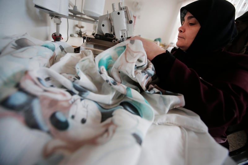 Syrian refugee women work at a sewing workshop at a refugee camp for Syrian refugees in Islahiye, Gaziantep province, southeastern Turkey,Wednesday, March 16, 2016. Nearly 300,000 are housed in 26 government-run camps similar to this one. The European Union and Turkey hope to reach a comprehensive deal this week to tackle illegal migration and the refugee crisis spurred by conflicts in Syria and beyond. In return for its efforts, Turkey stands to gain 3.3 billion US dollars in EU funding to help it improve the situation of the 2.7 million Syrian refugees already within its borders. (AP Photo/Lefteris Pitarakis)