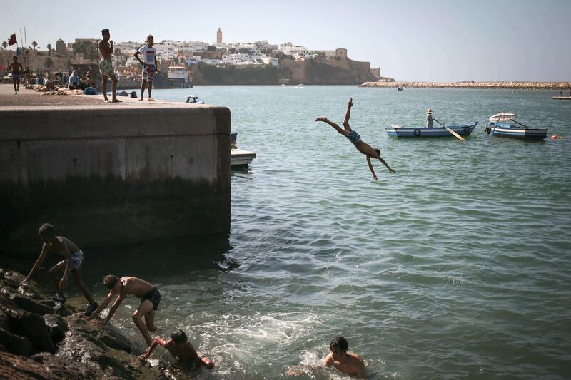 Boys jump into a river to cool down on a hot summer evening in Rabat, Morocco. AP Photo