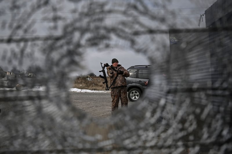 A Ukrainian serviceman stands at a check point in the vilage of Velyka Dymerka east of Kyiv. AFP